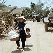Mama San carrying quit a load down Main Street Rach Kien
                                   June 1967.
