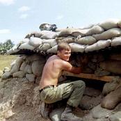 Cecil Clubb adjusting and fitting more sand bags at a bunker
                                   Rach Kien March 1967.
